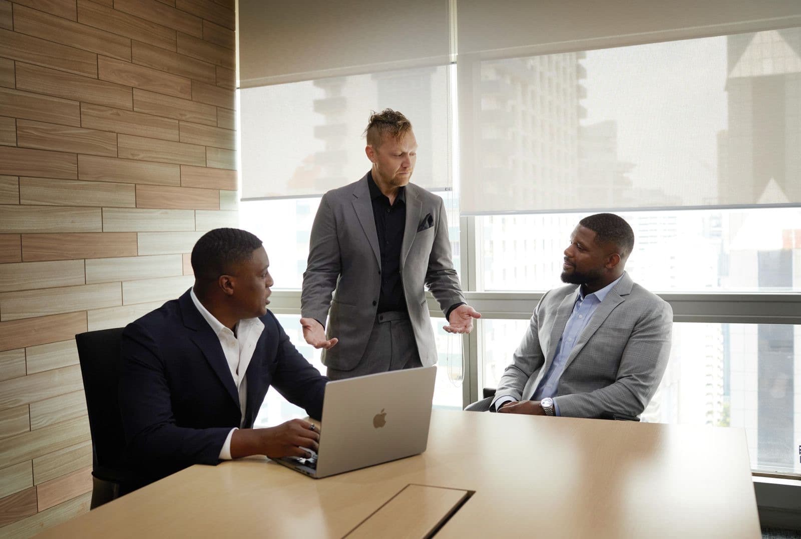 Three members of the Opsian team in a working session around a laptop