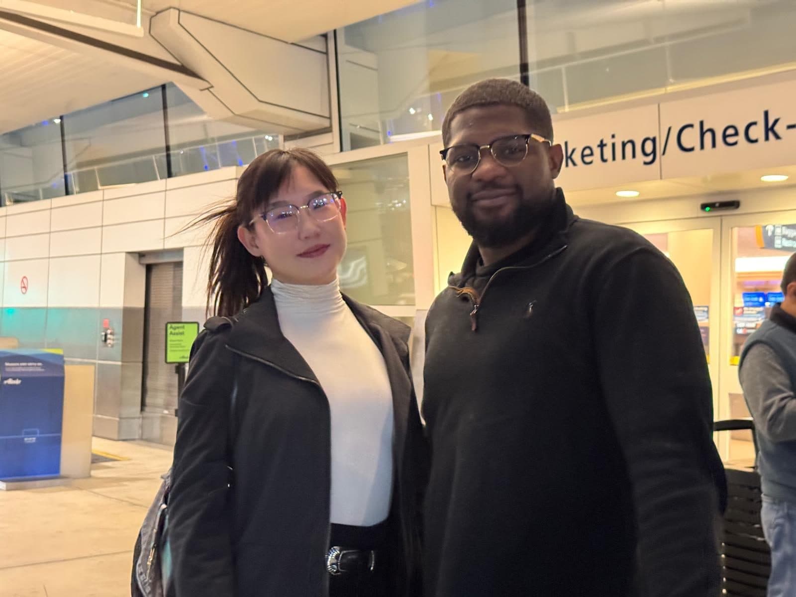 Patrick Che and Alice Liu at an airport check-in hall