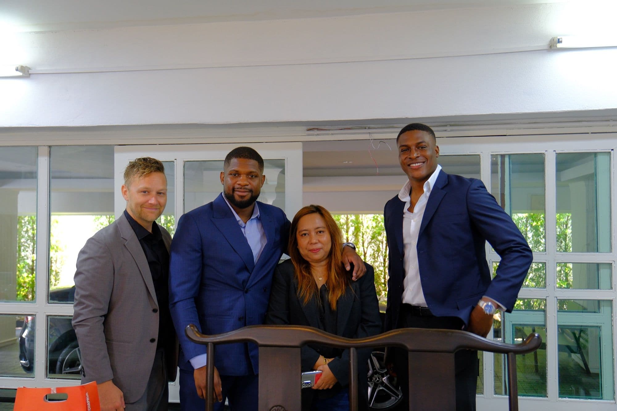 Opsian and RoomQuest team members standing together at an event
