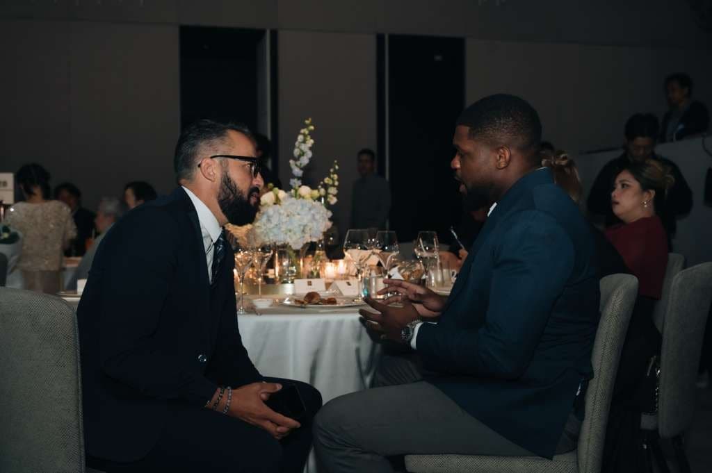 Patrick Che in conversation with Gillian Parsley at a table during the awards dinner